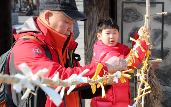 22일 동지를 맞아 열린 서울 남산골한옥마을 세시절기행사 ‘동지첨치’에 참가한 시민들이 소원을 적어 달고 있다. 2018.12.22  연합뉴스