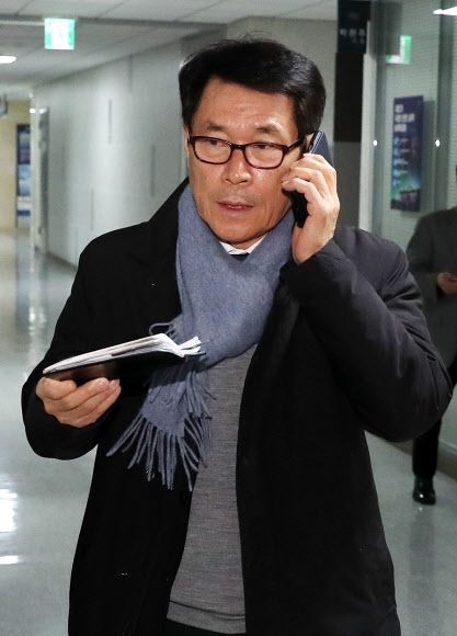 정치자금법 위반으로 의원직을 상실한 이군현 자유한국당 의원이 27일 통화를 하며 서울 여의도 국회 의원회관 사무실로 들어가고 있다.<br>연합뉴스
