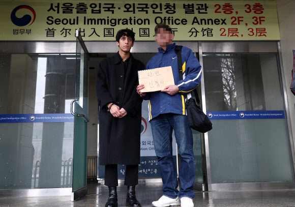 이란 난민 소년 김민혁군이 아버지의 난민 인정 재신청을 위해 19일 오전 서울 양천구 서울출입국외국인청 별관을 방문, 아버지와 난민인정신청서를 들고 있다. 김군의 아버지는 2심까지 행정소송을 진행했으나 패소했다. 2019.2.19  연합뉴스