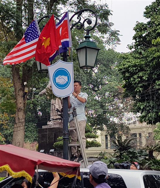 2차 북미정상회담을 일주일 앞둔 19일 베트남 하노이의 정부게스트하우스 앞에 관계자가 미국의 성조기와 베트남의 금성홍기, 북한의 인공기를 달고 있다. 2차 북미정상회담은 오는 27~28일 양일간 베트남 하노이에서 열린다. 2019.2.19 뉴스1