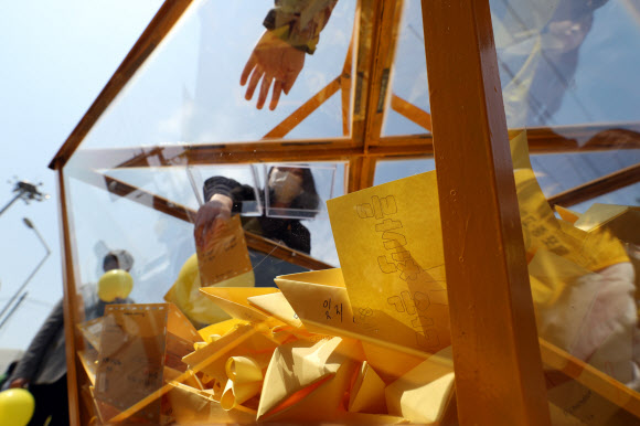 세월호 참사 5주기를 사흘 앞둔 13일 선체가 서 있는 전남 목포신항에서 학생들이 추모엽서를 써서 모으고 있다. 2019.4.13  연합뉴스