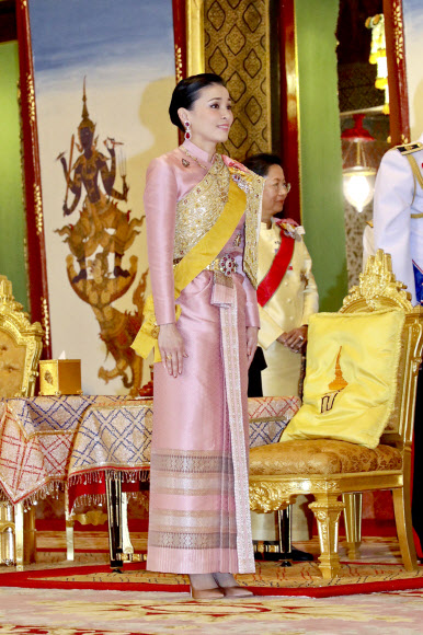In this photo released by Bureau of the Royal Household, Queen Suthida stands in attention during Thailand‘s King Maha Vajiralongkorn is officially crowned king at the Grand Palace, Saturday, May 4, 2019, in Bangkok, Thailand. Saturday began three days of elaborate centuries-old ceremonies for the formal coronation of Vajiralongkorn, who has been on the throne for more than two years following the death of his father, King Bhumibol Adulyadej, who died in October 2016 after seven decades on the throne. (Bureau of the Royal Household via AP)