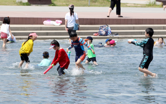 서울 낮 최고기온이 28도까지 오르며 초여름 날씨를 보인 11일 오후 서울 여의도 한강공원 물빛광장을 찾은 어린이들이 물놀이를 하고 있다. 2019.5.11  연합뉴스