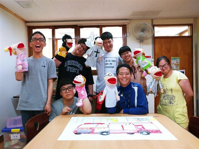 지난 5월 초 새얼학교에서 송이호(앞줄 오른쪽 두번째) 교사가 제자들과 함께 인형극을 준비하면서 환하게 웃고 있다.  송이호 교사 제공