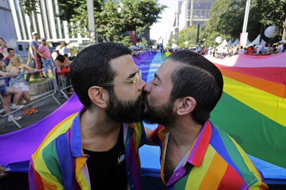 Revelers kiss during the annual gay pride parade along Paulista avenue in Sao Paulo, Brazil, Sunday, June 23, 2019. (AP Photo/Nelson Antoine)