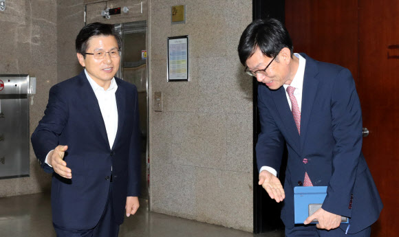 회의실 입장 권하는 황교안과 김상조