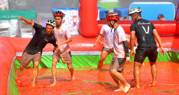 강원 화천군 사내면 문화마을에서 ‘토마토축제’가 한창인 가운데 주말을 맞은 3일 군장병이 토마토축구를 즐기고 있다.  2019.8.3   화천군 제공