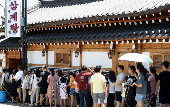 휴일이자 말복인 11일 오후 서울 종로구의 한 삼계탕 전문점을 찾은 시민들이 입장을 기다리고 있다. 2019.8.11  연합뉴스