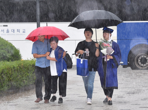 29일 서울 관악구 서울대학교에서 학생들이 비를 피하고 있다. 2019.8.29 박지환 기자 popocar@seoul.co.kr
