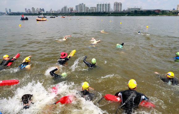 31일 서울 송파구 잠실한강공원에서 열린 ‘제13회 장애인수영 한강건너기 대회’에 참가한 장애인과 안전요원들이 1.6km 떨어진 뚝섬한강공원까지 수영으로 한강을 건너기 위해 출발하고 있다. 2019.8.31  연합뉴스