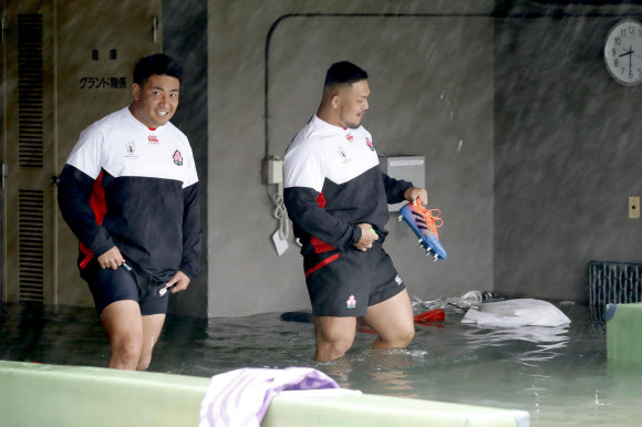 12일 태풍 ‘하기비스’의 영향으로 일본에 폭우가 쏟아진 가운데 일본 럭비팀 선수들이 스코틀랜드와 럭비월드컵 예선전을 앞두고 팀 훈련을 위해 도쿄의 한 경기장에 모여 연습에 돌입했다. AP 연합뉴스