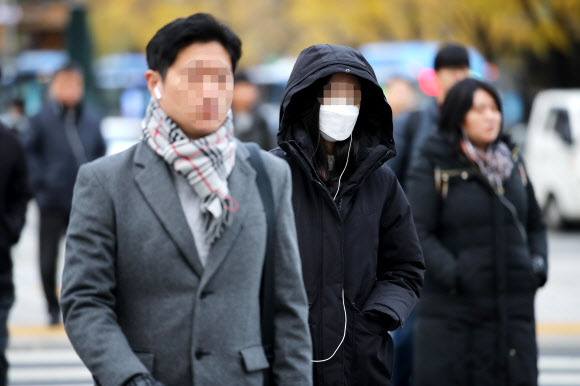 강한 바람이 분 18일 오전 서울 종로구 광화문네거리에서 시민들이 외투 주머니에 손을 넣은 채 발걸음을 재촉하고 있다. 2019.11.18  연합뉴스