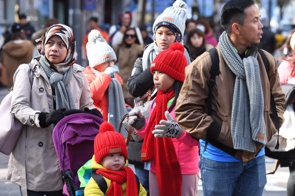 휴일부터 내리던 비가 그치고 쌀쌀한 날씨를 보인 18일 서울 중구 명동에서 관광객들이 두터운 외투와 방한용품을 착용하고 길을 걷고 있다. 2019. 11. 18 박윤슬 기자 seul@seoul.co.k