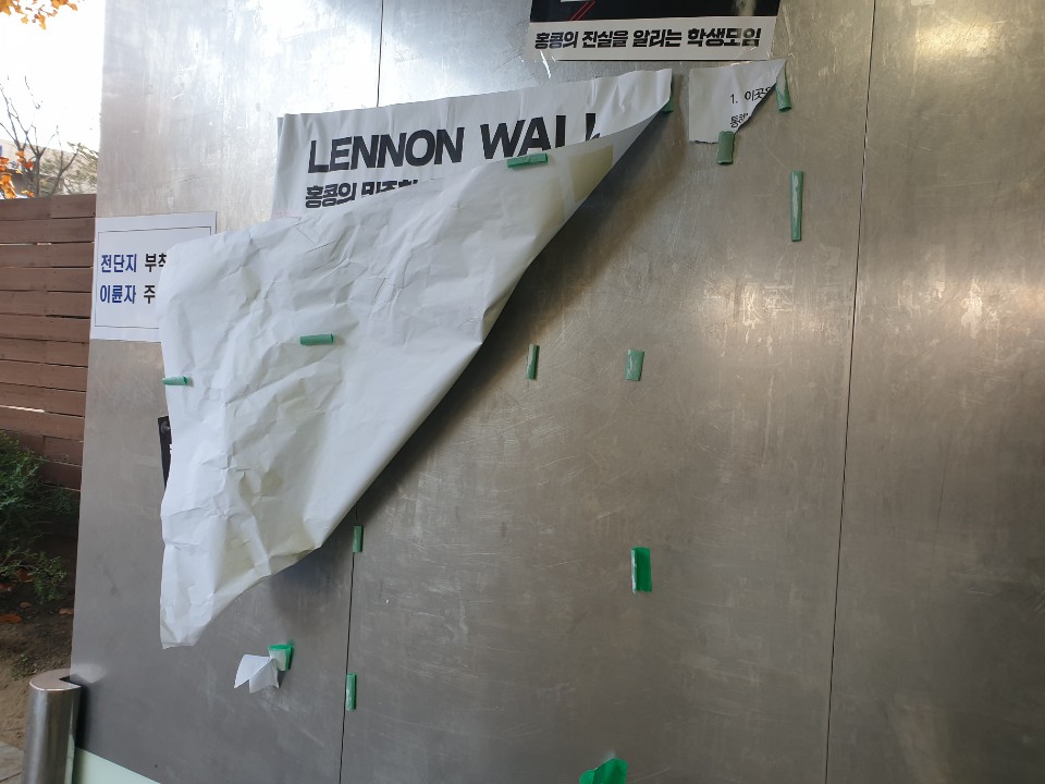18일 홍콩 시민들에게 연대와 지지를 표시하기 위해 서울대학교 교내에 설치됐던 ‘레넌 벽’ 일부가 훼손되어 있다. 홍콩 시민들에게 보내는 응원 문구를 포스트잇에 적어 부착할 수 있도록 해 둔 전지 두 장 중 한 장이 사라졌으며, 일부 찢어진 가장자리만 남아 있는 상태다. 2019.11.18 연합뉴스