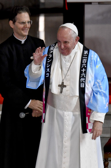 프란치스코 로마 가톨릭 교황이 일본 방문 사흘째인 25일(현지시간) 도쿄 성 메리 성당을 방문해 전통 셔츠를 선물받아 입고 인사를 하고 있다. 교황이 일본 왕궁을 찾은 것은 1981년 요한 바오로 2세 교황의 방일 때에 이어 38년 만이다. EPA 연합뉴스