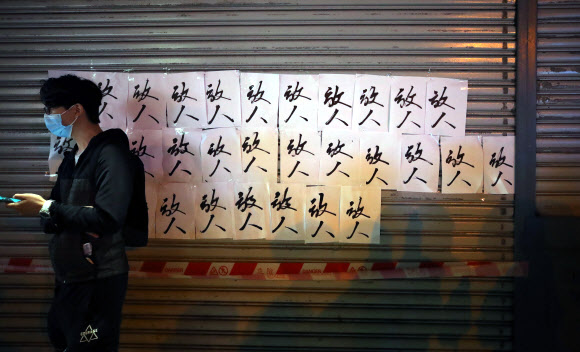 26일 오전 홍콩 이공대학 앞 한 건물에 이공대에 남은 시위대를 응원하는 문구가 붙어있다. 2019.11.26  연합뉴스