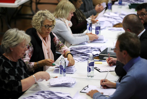 12일(현지시간) 영국 이셔에서 직원들이 총선 개표를 하고 있다. 로이터 연합뉴스