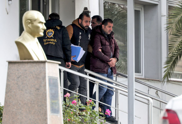 터키 경찰이 3일 이스탄불에서 카를로스 곤 전 르노·닛산 얼라이언스 회장의 일본 탈출을 도운 혐의를 받고 있는 용의자를 임의동행 식으로 연행하고 있다. 이스탄불 AP 연합뉴스 