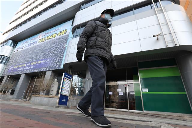 19일 대구,경북에서 신종 코로나바이러스 감염증(코로나19) 확진자가 13명 추가로 발생한 가운데 한 시민이 국내 31번째 확진자가 다녀간 대구 남구 대명동 신천지 대구교회 앞을 지나고 있다. 2020.2.19 뉴스1