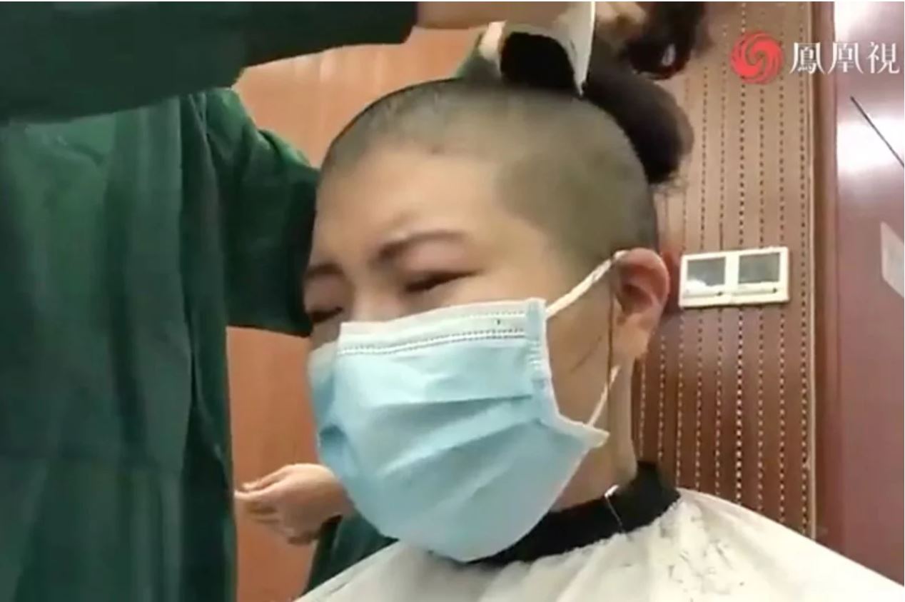 코로나19 바이러스가 창궐한 중국 후베이성 우한의 한 간호사가 보호복을 입는 시간을 줄이고자 머리를 자르면서 눈물을 흘리고 있다. 출처:사우스차이나모닝포스트