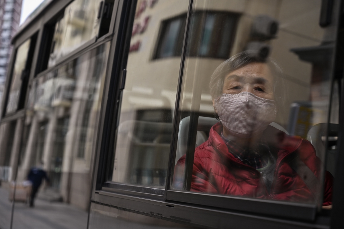 2일(현지시간) 중국 상하이의 한 버스에서 승객이 마스크를 쓴 채 창 밖을 내다보고 있다. 2020.3.2  AFP 연합뉴스