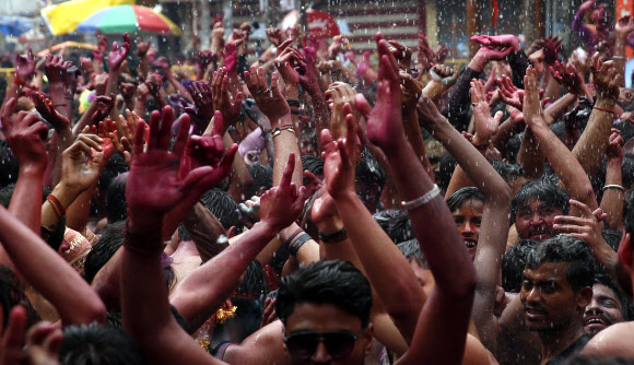 인도인들이 10일(현지시간) 인도 프라야그라즈에서 힌두교의 색채 축제인 ‘홀리’를 기념하며 색 스프레이 물에 흠뻑 젖어 춤을 추고 있다. AP 연합뉴스