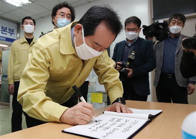 정세균 국무총리가 14일 오전 신종 코로나바이러스 감염증(코로나19) 확진자 진료 지역거점병원인 대구 중구 계명대 대구동산병원을 찾아 비상대책본부에 마련된 방명록에 감사와 응원의 메시지를 남기고 있다. 2020.3.14 뉴스1