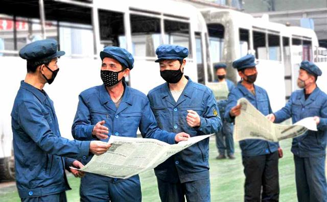 北 김정은 ‘종합병원 건설 착공식 연설’ 읽는 북한 노동자들