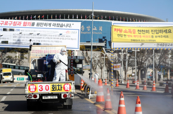 코로나19 집단감염 방지를 위해 정부가 종교 집회 등 밀집 행사 중단을 강력히 권고했음에도 불구하고 22일 예배를 강행한 구로구 연세중앙교회에서 교회 관계자들이 방역작업을 하고 있다. 2020.3.22  연합뉴스