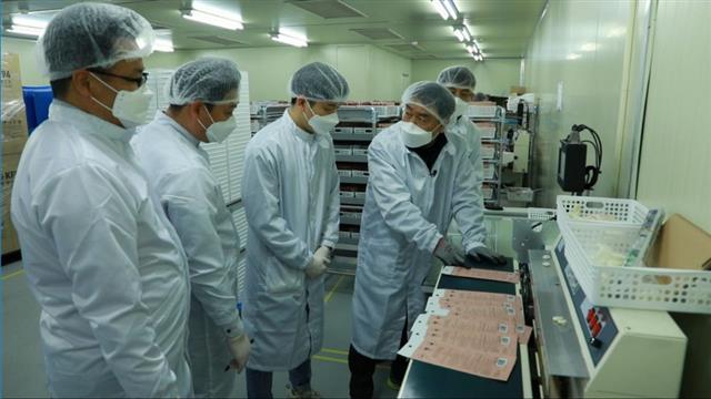지난 16일 대전 유성구의 마스크 제조업체 레스텍을 찾은 삼성전자 스마트공장 지원센터의 제조설비 전문가들이 마스크 생산량 극대화를 위해 제조 공정을 개선해 주고 있다. 삼성전자 제공
