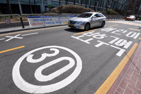 학교 앞 어린이 보호구역에서 교통사고가 발생했을 때 운전자 처벌을 대폭 강화하는 내용의 ‘민식이법’이 시행된 지난 3월 25일 서울 성동구 한 초등학교 앞 도로에서 차들이 달리고 있다. 박윤슬 기자 seul@seoul.co.kr