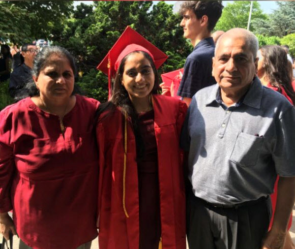 Minnoli Aya poses with her parents Raj and Madhvi on her graduation day