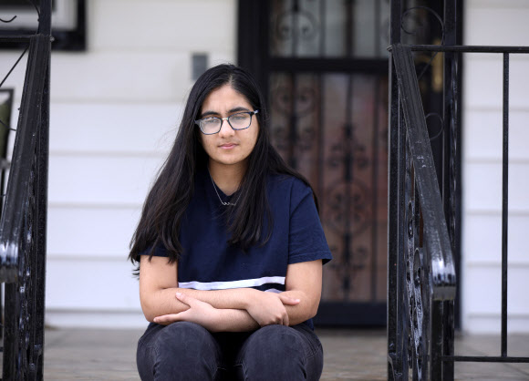 19-year-old Minnoli Aya, who lost her mother Madhvi, a healthcare worker, during the outbreak of the coronavirus disease (COVID19), looks on in Floral Park, New York