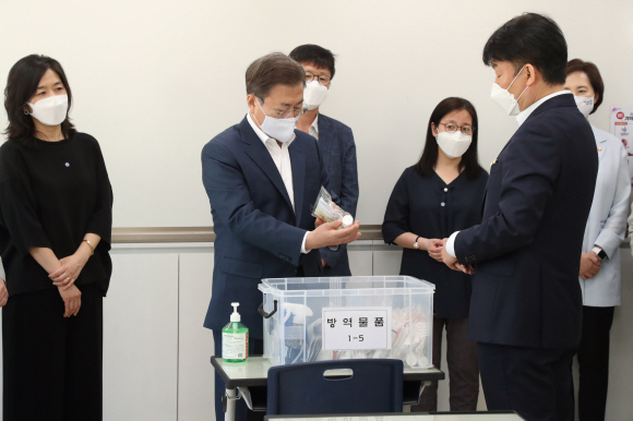 문재인 대통령이 8일 코로나19 사태로 인해 등교개학이 거듭 연기되었다가 다음 주 등교개학을 앞둔 서울 용산 중경고등학교를 방문, 개학 준비상황을 직접 점검하고 철저한 대비를 당부했다.  문대통령이 학부모들과 함께 일반교실을 찾아 감염예방조치 및 방역물품 관련 설명을 듣고있다.  2020.5.8 도준석 기자 pado@seoul.co.kr