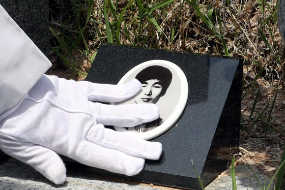 5·18 민주화운동 40주년을 하루 앞둔 17일 오전 광주 북구 운정동 국립 5·18민주묘지에서 김경철 열사의 어머니가 아들의 묘소를 찾아 영정을 어루만지고 있다. 2020.5.17  연합뉴스