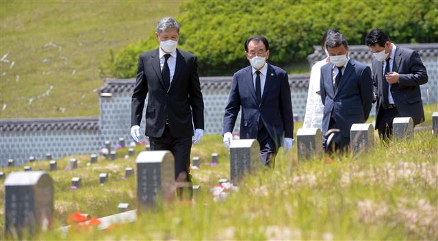 노태우 전 대통령 아들 노재헌씨가 29일 광주 북구 운정동 국립5?18민주묘지에서 헌화·분향을 마친 뒤 김후식 전 5·18부상자회장과 함께 묘역을 둘러보고 있다.  노씨는 참배에 앞서 방명록에 ‘5·18 광주민주화운동 40주년을 기리며 대한민국 민주화의 씨앗이 된 고귀한 희생에 고개숙여 감사드립니다’라고 적었다. 또 ‘제13대 대통령 노태우-5·18민주영령을 추모합니다’라고 적힌 조화를 헌화했다. 20205.29 뉴스1