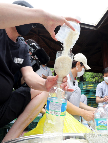 18일 오전 탈북자 단체 사단법인 큰샘 관계자들이 서울 강남구 수서동의 한 공원에서 오는 21일 북으로 보낼 쌀을 페트병에 담고 있다. 2020.6.18  연합뉴스