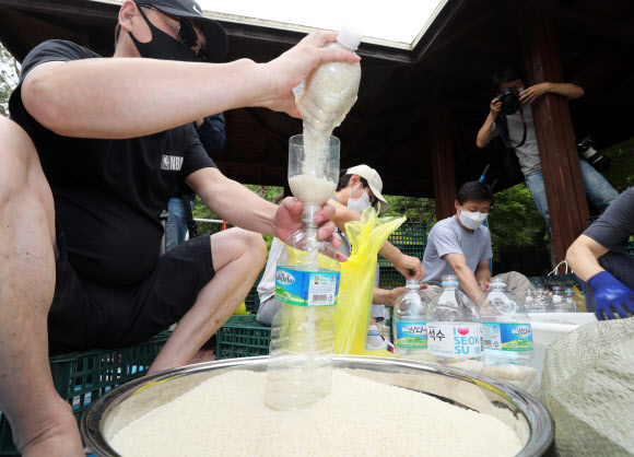 18일 오전 탈북자 단체 사단법인 큰샘 관계자들이 서울 강남구 수서동의 한 공원에서 오는 21일 북으로 보낼 쌀을 페트병에 담고 있다. 2020.6.18  연합뉴스