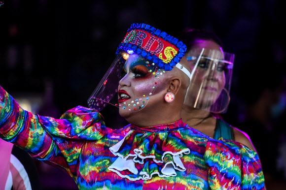 한 여성이 26일(현지시간) 미국 플로리다주 마이애미 비치 오션 드라이브에 있는 식당 안에서 사진을 찍고 있다. AFP 연합뉴스