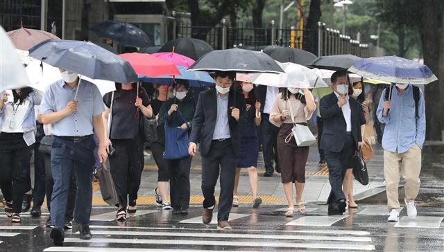 절기상 1년 중 가장 덥다는 대서(大暑)인 22일 서울 종로구 사직로 인근에서 우산을 쓴 시민들이 발걸음을 재촉하고 있다. 2020.7.22 뉴스1