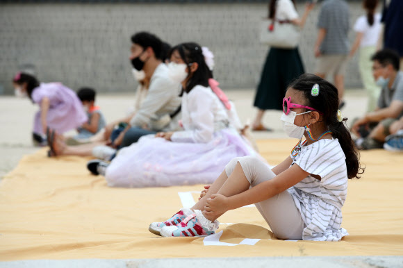 신종 코로나바이러스 감염증(코로나19)으로 문을 닫았던 수도권 문화시설들이 재개관한 뒤 첫 주말을 맞은 26일 서울 종로구 경복궁을 찾은 한 어린이가 수문장 교대의식을 관람하고 있다. 2020.7.26  연합뉴스