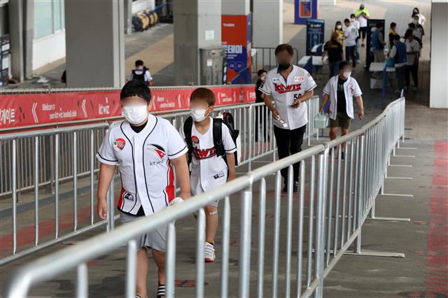 프로야구 관중 입장 첫날인 26일 오후 경기도 수원시 장안구 kt위즈파크에서 열린 2020 프로야구 신한은행 SOL KBO리그 kt위즈와 NC다이노스의 경기 시작에 앞서 관중들이 신종 코로나바이러스 감염증(코로나19) 확산 방지를 위해 거리를 두고 입장하고 있다. 2020.7.26 뉴스1