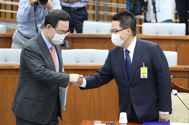 박지원 국가정보원장 후보자가 27일 오전 서울 여의도 국회 정보위 전체회의에서 열린 국정원장 후보자 인사청문회에서 주호영 미래통합당 원내대표와 악수하고 있다.  박 후보자 인사청문회는 학력위조 의혹과 대북관 등이 쟁점이 될 예정이다. 2020.7.27 뉴스1