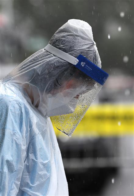 경기 고양시가 소규모교회 집단감염 확산이 빠르게 진행됨에 따라 9일부터 ‘고양안심카 선별진료소’ 재운영에 들어갔다. 9일 고양시 덕양구 주교 제1공영주차장에 마련된 ‘고양안심카 선별진료소’에서 의료진이 폭우 속에서 일을 하고 있다. 2020.8.9 뉴스1