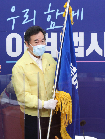 31일 오후 국회 더불어민주당 대표회의실에서 당기전달식이 열린 가운데 이낙연 당대표가 김영주 전국대의원대회 의장에게 당기를 전달 받고 있다. 2020. 8. 31 김명국 선임기자 daunso@seoul.co.kr