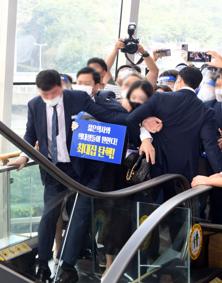 대한의사협회 2020년도 임시대의원총회가 열린 27일 서울 서대문구 스위스 그랜드호텔 서울 컨벤션센터에서 대한병원의사협의회 비대위 등 의사들이 최대집 회장 탄핵과 비대위 구성에 대해 대의원 설득을 위한 피켓 시위를 하며 총회장 진입을 시도하다 경호원들과 대치하고 있다. 2020. 9. 27 오장환 기자5zzang@seoul.co.kr