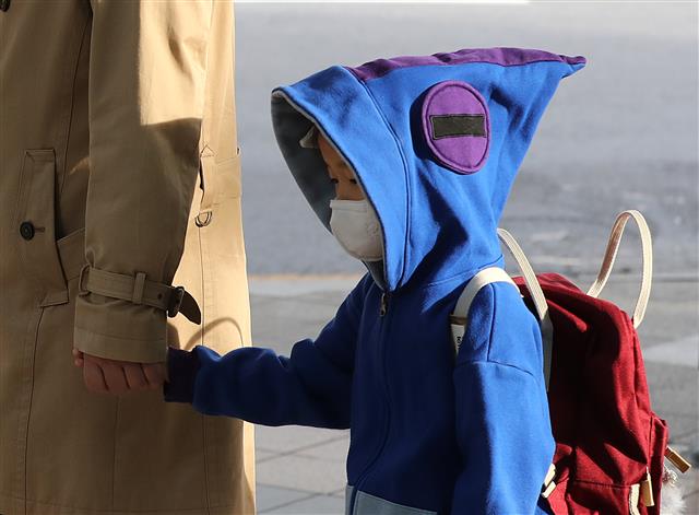 쌀쌀해진 날씨, 모자 뒤집어쓴 아이