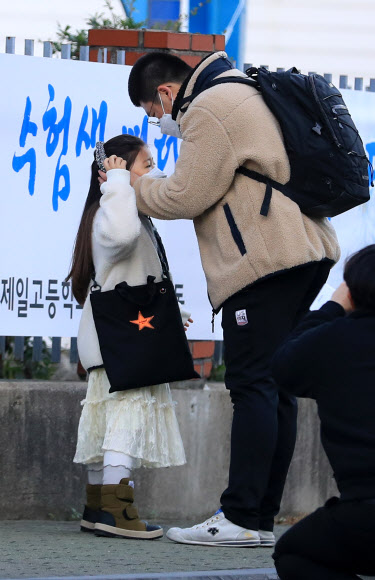 2021학년도 대학수학능력시험일인 3일 오전  제주도교육청 제95지구 2시험장이 마련된 제주시 제주제일고 정문에서 한 수험생이 어린 여동생의 격려를 받고 있다. 2020.12.3  연합뉴스