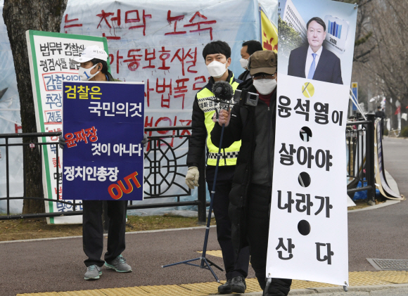 윤석열 검찰총장에 대한 법무부 검사징계위원회가 열린 10일 오전 과천정부청사 앞에서 윤 총장 퇴진을 요구하는 1인 시위자와 윤 총장을 지지하는 1인 시위자가 나란히 서서 피켓을 들고 있다.<br>박지환 기자 popocar@seoul.co.kr