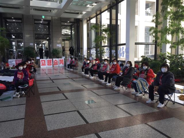 서울 여의도 LG트윈타워 청소노동자들이 31일 사옥 로비에서 고용 승계를 촉구하고 있다.